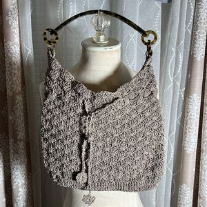 Crochet Works bag with acrylic shoulder strap.